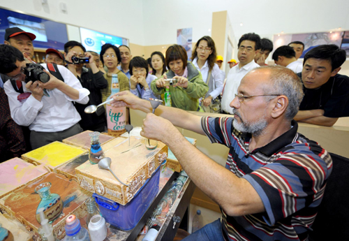 Brothers make sand art bottles at Expo