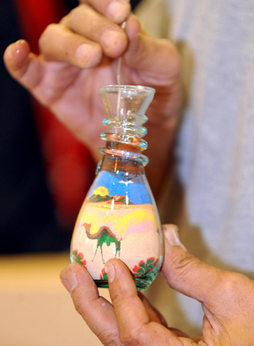 Brothers make sand art bottles at Expo