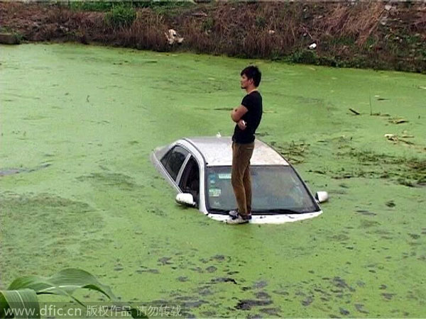 Calm driver waits on top of sinking car for help