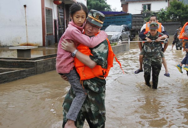 Rescuers pluck residents from raging torrent