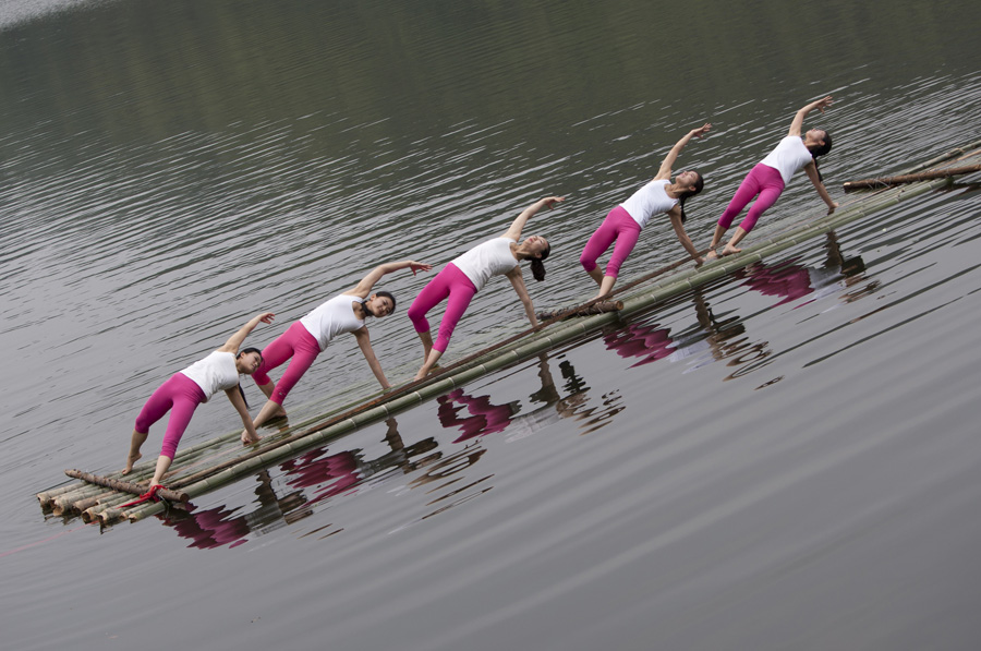 Yoga enthusiasts dance in water