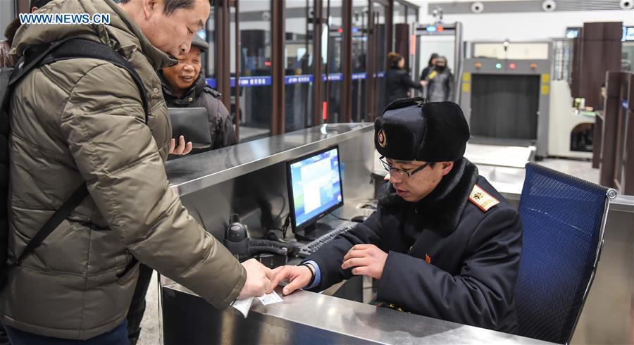 Young couple as railway workers busy for Spring Festival travel rush