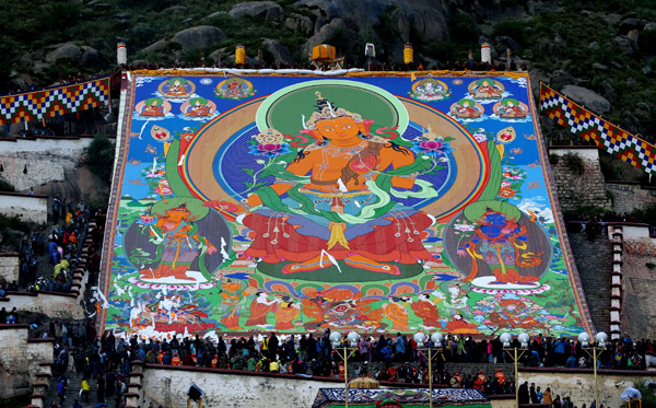 <EM>Thangka</EM> adorns hillside during Shoton