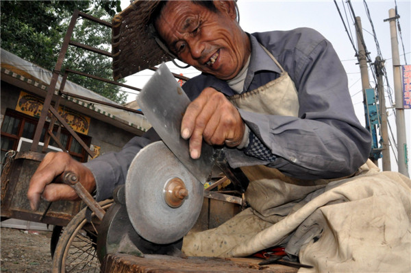 Man grinds knives for life