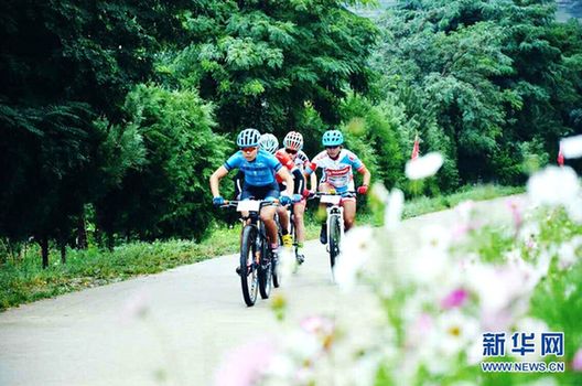 Mountain bikers race through lush landscape in Zhuanglang