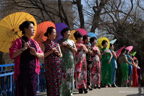 Women present cheongsam to mark coming International Women's Day in North China