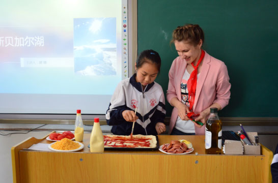 Foreign students volunteering teaching for village students