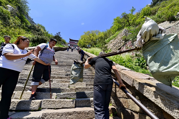 Porters see a steep drop on Taishan Mountain