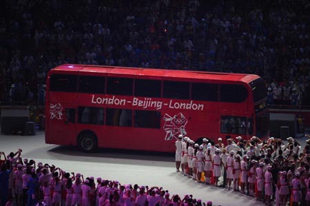 The photo taken on Aug. 24, 2008 shows a red double-decker bus during the eight-minute performance prepared by London, host city of the next summer Olympic Games in 2012, at the Beijing 2008 Olympic Games closing ceremony held in the National Stadium, or the Bird's Nest, Beijing, capital of China.