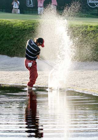 Sergio Garcia of Spain hits from the water on the 17th hole during the third round of the Bay Hill Invitational PGA golf tournament in Orlando, Florida, March 18, 2006. Garcia scored a bogey four on the hole and finished the round eight-under-par for the tournament with a 208 total.