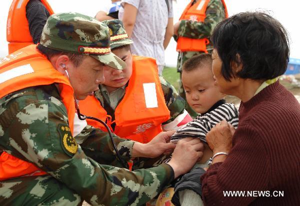 Rescuers help villagers evacuate to safe places in S China