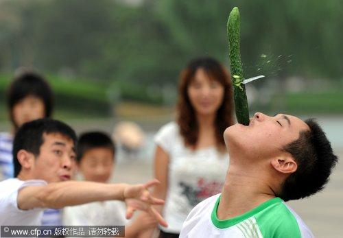 Poker card slices through a cucumber