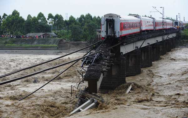 Train cars fall into river in SW China, no injuries