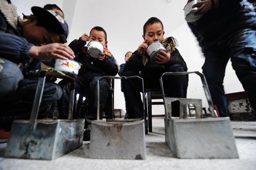 Pupils take up books, pens, and hand-stoves