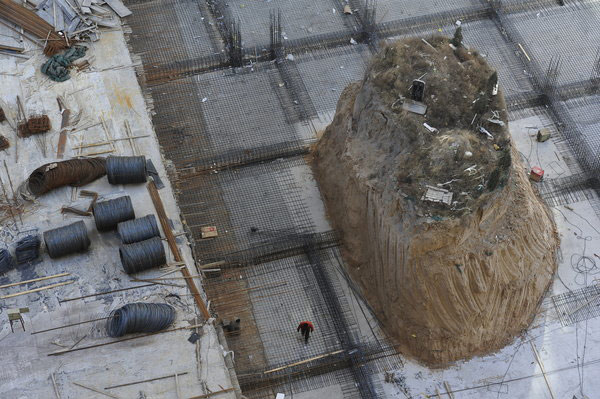 Mound of graves amid construction activity