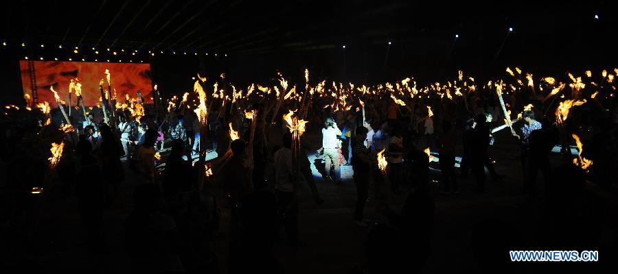 Tourists, performers mark traditional Torch Festival in SW China